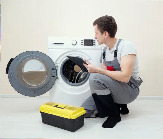 Technician inspecting a front-loading washing machine