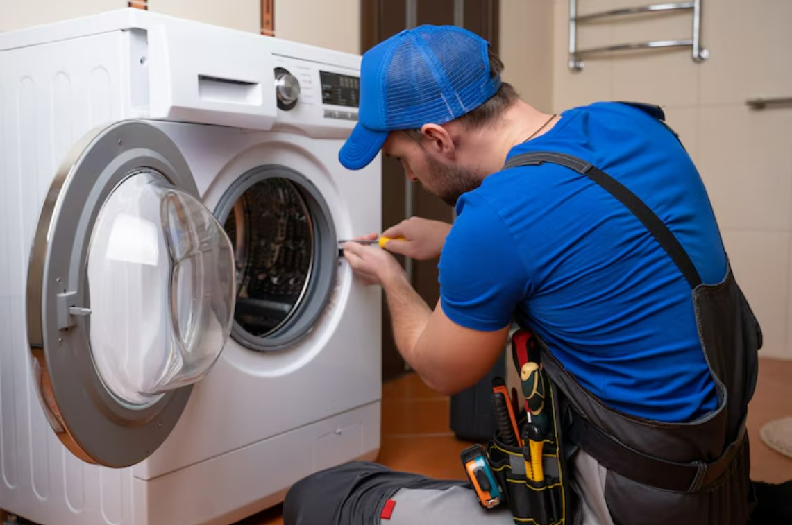 LG washing machine repair technician servicing a front-load washer in Vancouve